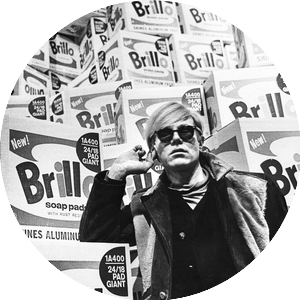 Image of Andy Warhol in front of Brillo boxes